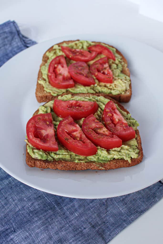 Toast with smashed avocado and sliced tomato