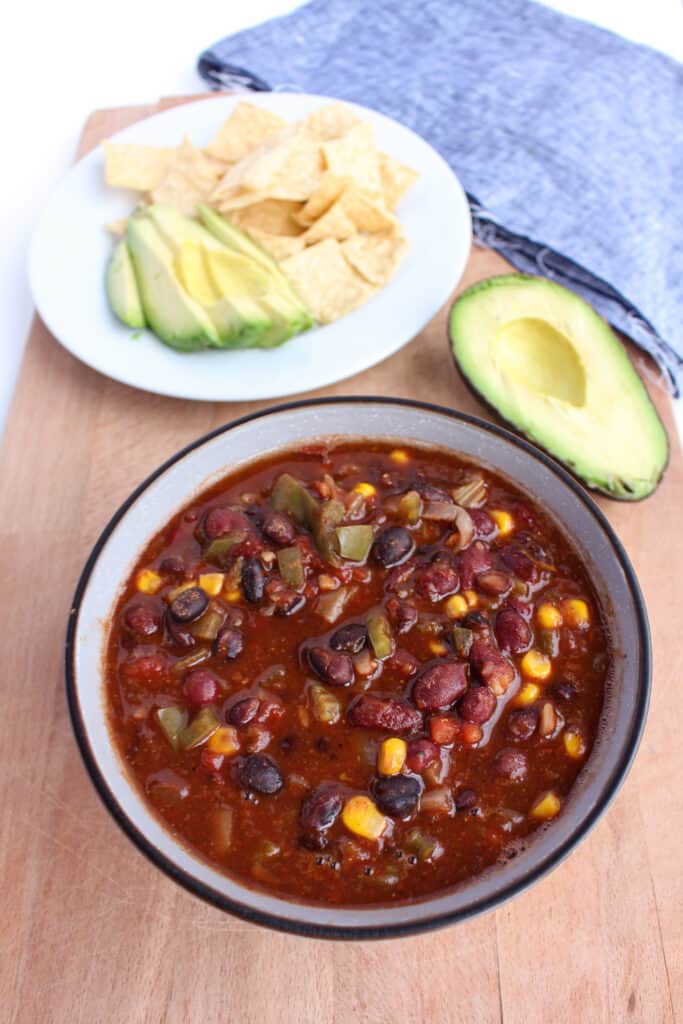 2 bean chili served with tortilla chips and avocado