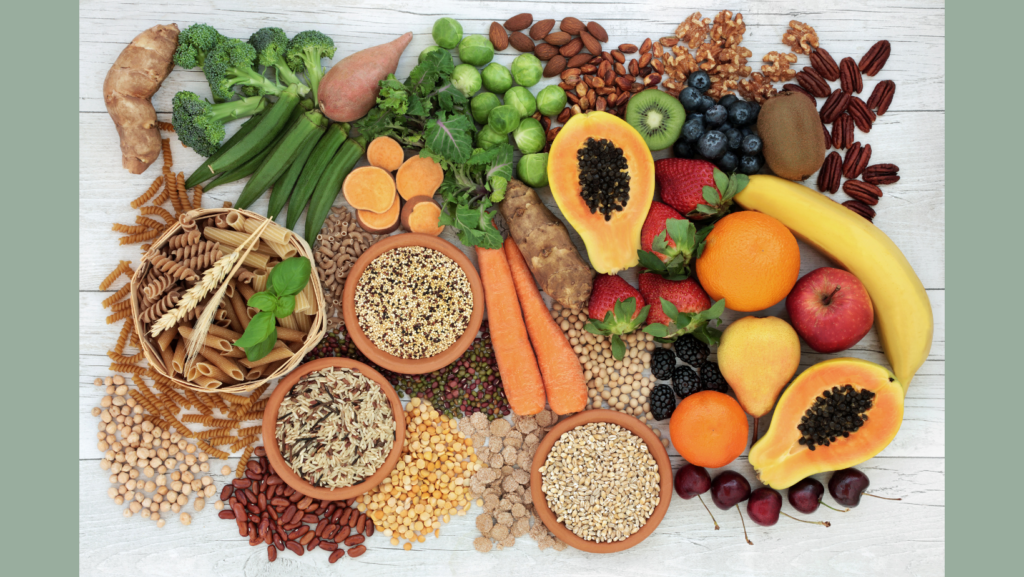 Overhead view of a vareity of fruits, vegetables, whole grains, nuts, seeds and legumes. 
