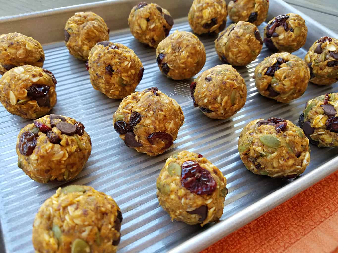 A baking sheet full of No Bake Peanut Butter Pumpkin Balls