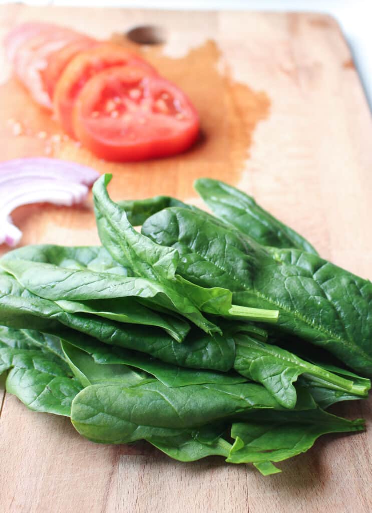 Fresh spinach, sliced tomatoes and red onion