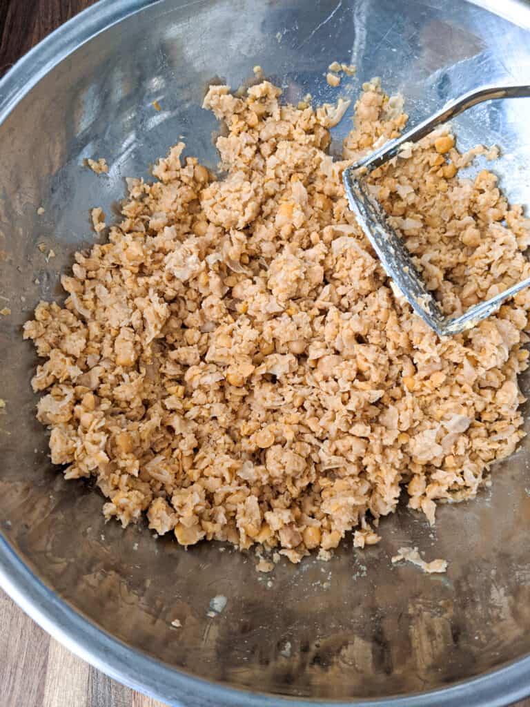 Chickpeas mashed with a potato masher to resemble the consistency of tuna